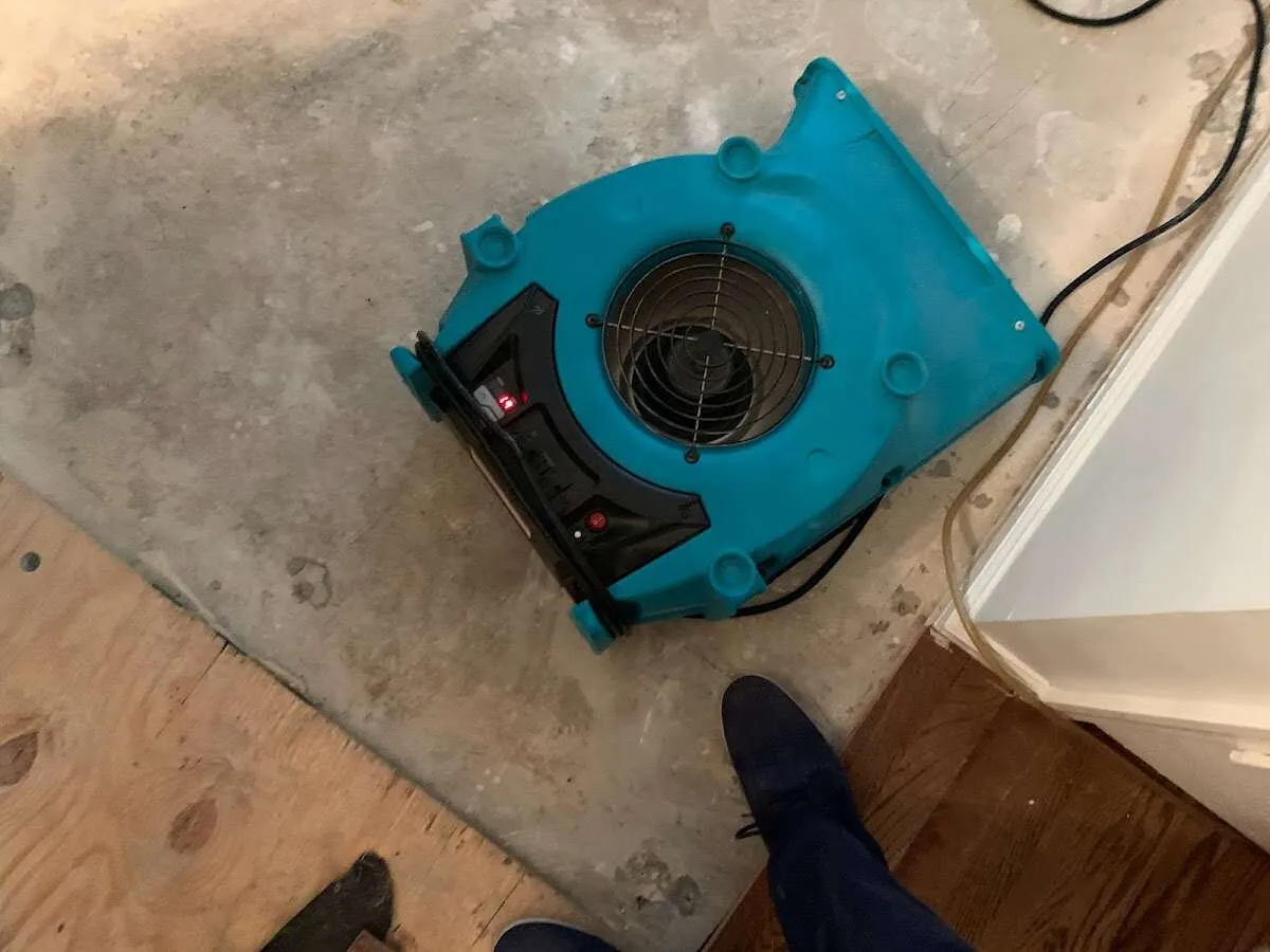 Air mover drying subfloor during Commercial Water Damage Restoration in Manheim